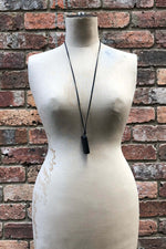 Load image into Gallery viewer, Mid 20th Century Leather Shrouded Bakerlite Single Domino Neckpiece
